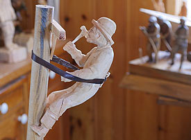 Carving of a hydo worker on a hydro pole